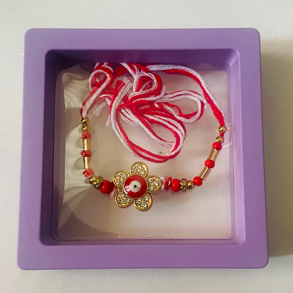 Red and White Floral Rakhi with Gold Petal Charm