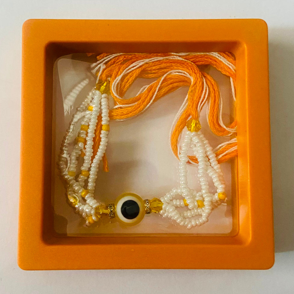 Golden Yellow Evil Eye Pearl Rakhi