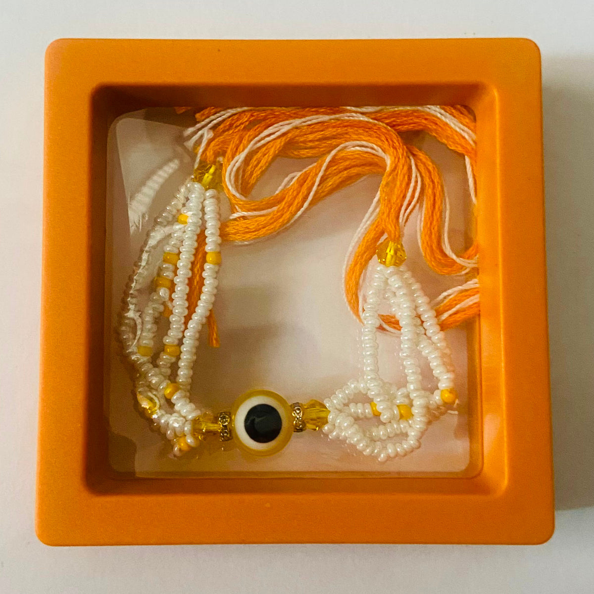 Golden Yellow Evil Eye Pearl Rakhi